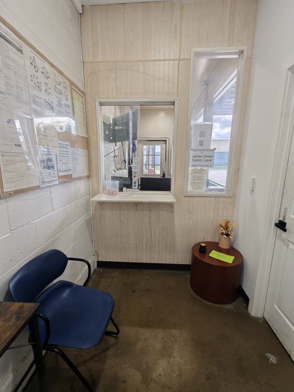 Customer check-in window inside the James Drive Safety Lane office.